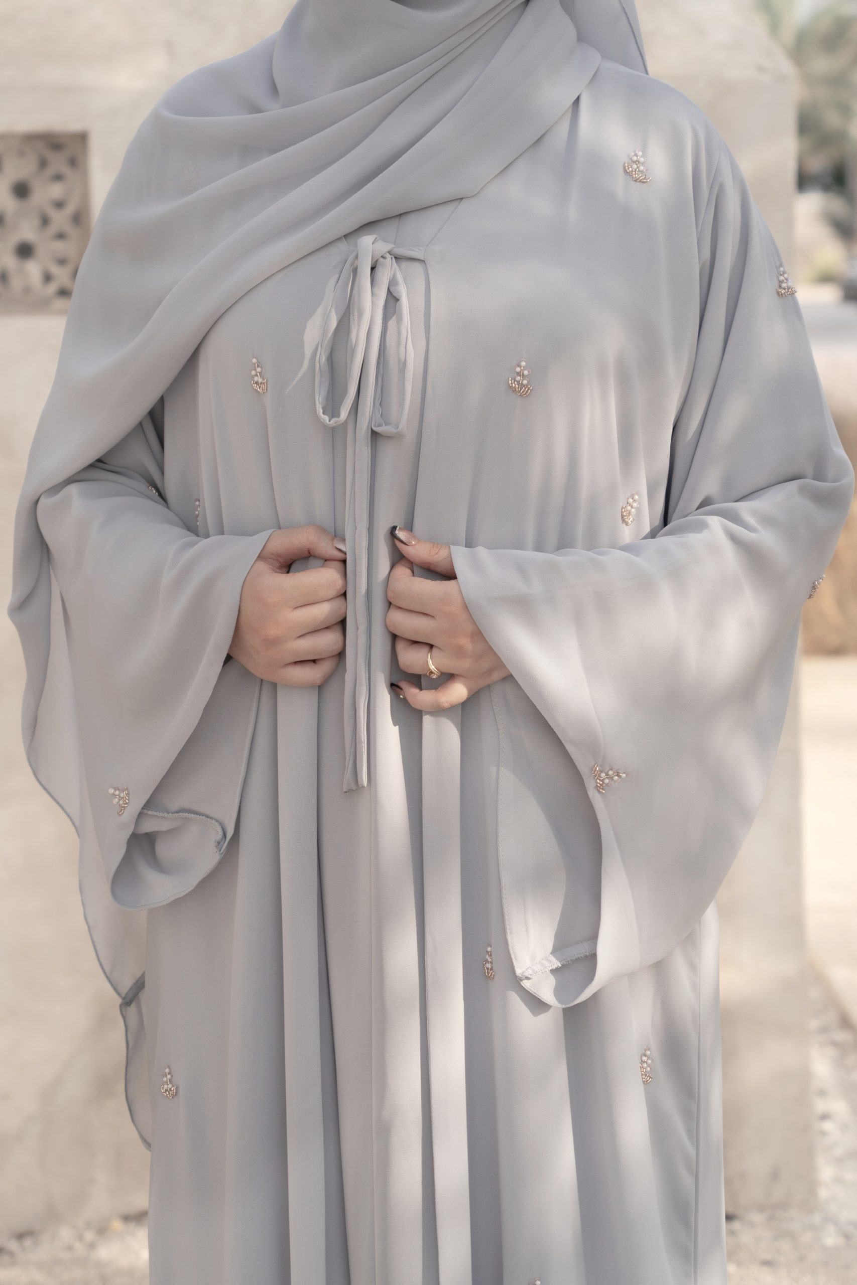 Ela Collection — Luxury 3-Piece Abaya Set A stunning wide A-line silhouette with enchanting butterfly sleeves, crafted from exquisitely soft chiffon. Adorned with intricate beadwork floral motifs for a touch of refined elegance.