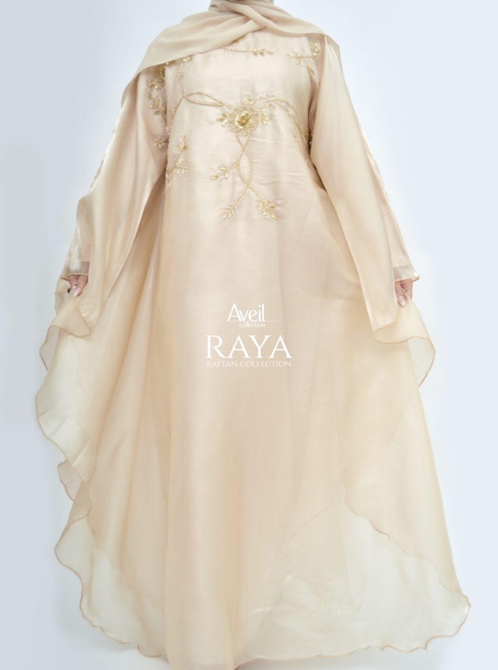 Model wearing Raya Luxury Closed Kaftan Abaya in satin with batwing silhouette and gold pearl embroidery